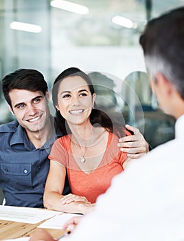 Theyre getting excellent financial advice. Happy young couple in a meeting with a financial consultant.