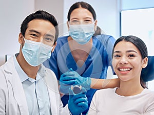 Theyre happy to be here. a young dentist and his assistant with their patient.