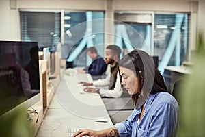 Theyre innovators of the creative world. a group of designers working on computers in an office.