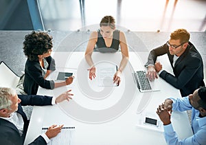 Theyre innovators. Shot of a group of businesspeople having a meeting together in an office.
