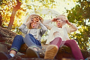 Theyre just being silly. Portrait of two little children playing together outdoors.