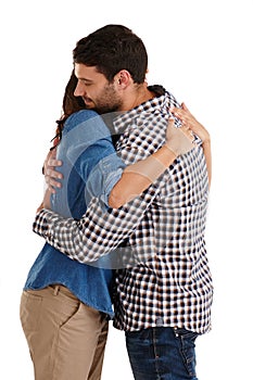 Theyre so in love. Studio shot of an affectionate young couple hugging isolated on white.