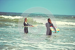 Theyre a match made in surfing heaven. a young couple surfing at the beach.