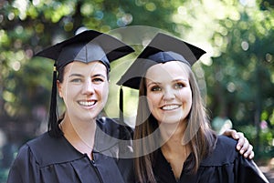 Theyre proud graduates. A portrait of two female students on graduation day.