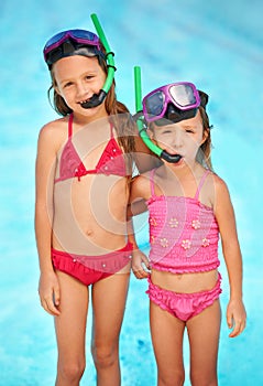 Theyre sisters who love swimming. two young sisters swimming together.