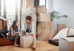 Theyre starting a new life together. Full length shot of an attractive young woman and her daughter moving into a new