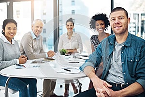 Theyre a team of innovators. Portrait of a group of colleagues sitting together in a boardroom.