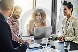 Theyre a team of overachievers. a group of colleagues meeting in the boardroom.