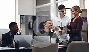 Theyre a team who diligently and cooperatively work together. a group of businesspeople having a discussion in an office