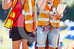 Theyre there to serve. two young female event staff members at an outdoor festival.