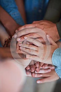 Theyre in it to win it. High angle shot of university students hands in a huddle.