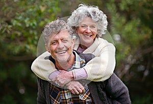 Theyre young at heart. Portrait of a loving senior couple standing together outdoors.