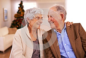 Theyve seen many Christmases together. an affectionate senior couple on Christmas day.