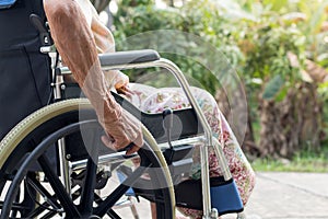 Theâ€‹ Asian senior or elderly old lady woman patient on wheelchair at the front house,healthy strong medical concept