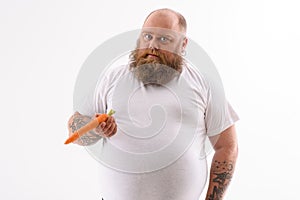 Thick bearded guy with healthy vegetable