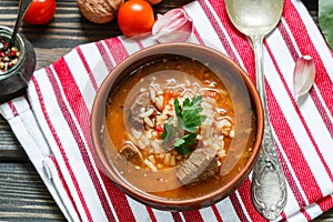 Thick beef soup with rice, tomatoes, carrots, peppers, walnuts and spices. Kharcho soup. A traditional dish of Georgian cuisine.