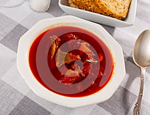 Thick beetroot soup with beef served for lunch