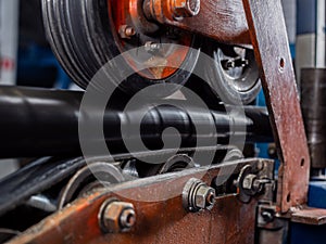 A thick black-wrapped power cable runs through the crimping and sealing section of the production line at the factory.