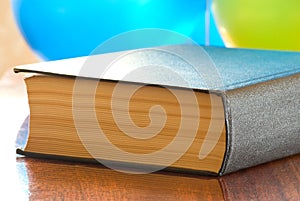 Thick book on a polished table