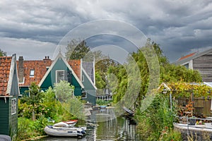 Thick Clouds Over Rural Dutch Houses and Boats on the Canal