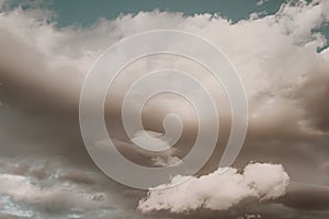 Thick cumulus clouds with pink tint at sunset. Background natural color of cloudscape panorama