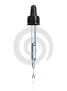 Thick drop is dripping down from cosmetic pipette isolated on a white background