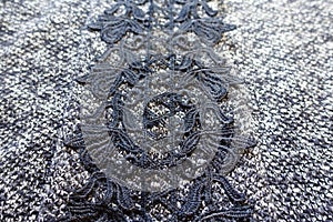 Thick grey woolen fabric with vertical stripe of black lace