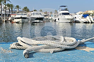 A thick hawser rope in spanish marina of Menorca island photo