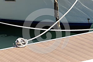 Thick hemp rope on the pier in the seaport.