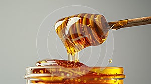 Thick honey pouring from dipper with a golden glow.