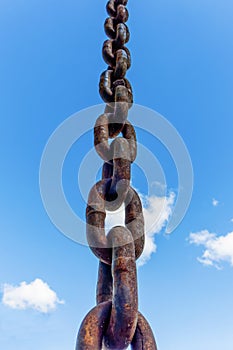 A thick iron chain to divert rainwater from close-up photo