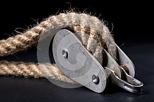 Thick jute rope wrapped on rollers in a sailing pulley. Accessories used on yachts for sailing in the sea