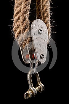 Thick jute rope wrapped on rollers in a sailing pulley. Accessories used on yachts for sailing in the sea