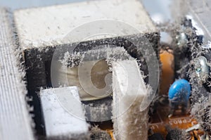 A thick layer of dust covers the internal electronic components of the computer