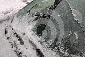 Thick layer of ice covering car after freezing rain