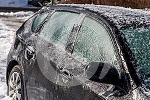 Thick layer of ice covering car