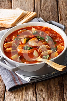 Thick Manhattan chowder soup close-up. Vertical