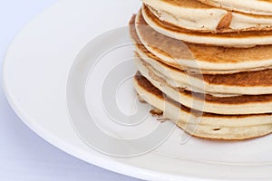 Thick pancakes are stacked on a plate