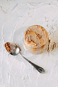 Thick peanut butter in a jar close-up. Healthy