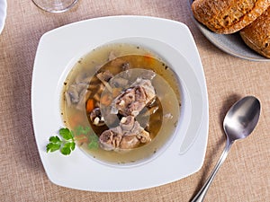 Thick pearl barley mushroom soup with pork and vegetables