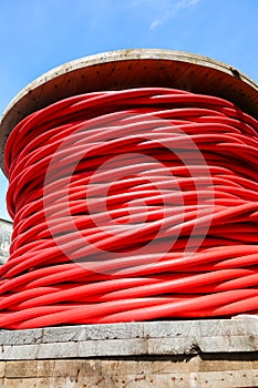 Thick red insulated electrical cable reel for high voltage