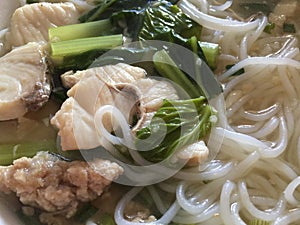 Rice noodle in soup with fish and vegetables