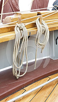 Thick ropes hanging on ship hull