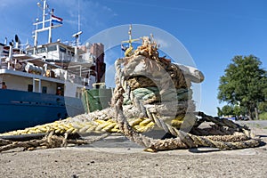 Thick ropes wrapped around a mooring post