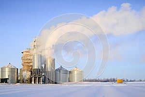 Thick steam from the pipes of a grain drying plant