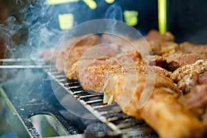 A thick strip steak being grilled outdoors