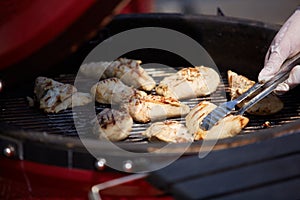 Thick strip steak being grilled outdoors. Shallow dof