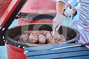 Thick strip steak being grilled outdoors. Shallow dof