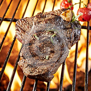 Thick succulent lean rump steak grilling on a fire