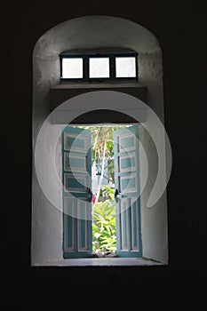 Thick walls as shown on side window of Mahatao church.